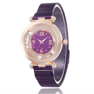 Detail of purple glitter dial watch with rolling diamonds and magnetic mesh band