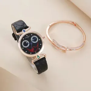 Women's quartz watch set with black leather strap, clown face dial and rose gold bracelet