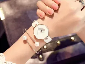 Detail of octagonal white quartz watch with rose gold case and pearl bracelet set