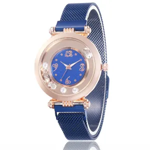 Detail of blue starry sky watch face with rose gold case and sparkling crystal accents