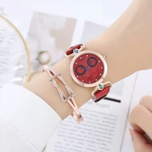 Close-up of a women's red quartz watch with a matching rose gold zircon bracelet