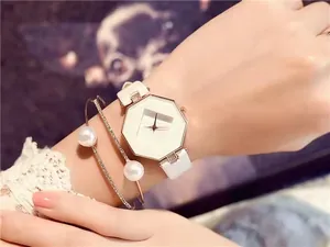 Octagonal white watch dial with elegant pearl bracelet and diamond-set bangle set