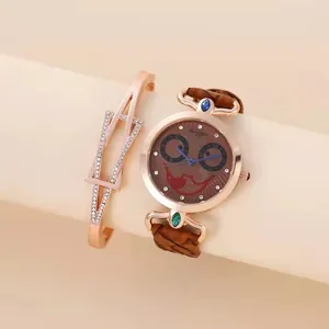 Rose gold watch and bracelet set with brown joker dial and leather band on display