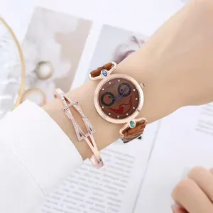 Detail of rose gold quartz watch with crocodile pattern strap and crystal-set bracelet