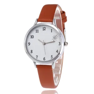 Detail of round silver watch case with white dial and textured brown leather strap