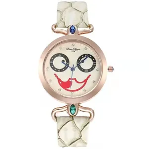 Detail view of clown face dial with crystal accents and white snakeskin pattern leather strap