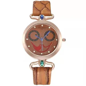 Detail of owl face watch dial with crystals, blue hands and brown leather strap
