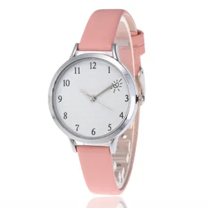 Detailed macro view of the pink faux leather strap and silver case of the quartz watch