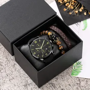 Macro view of men's watch and bracelet set with leather accents in a black gift box