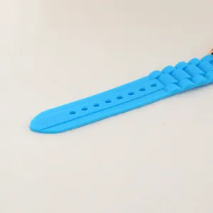 Détail d'un bracelet de montre en silicone bleu ciel avec texture nervurée et trous réglables