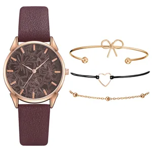Dettaglio orologio in pelle bordeaux con quadrante floreale e set gioielli coordinati