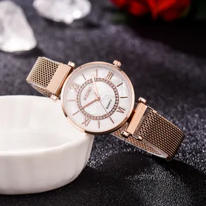 Elegant rose gold women's watch with Milanese strap and rhinestone dial in a lifestyle setting