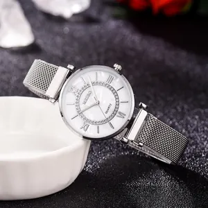 Detailed close-up of a silver ladies' watch with a white dial and diamond-set bezel decoration