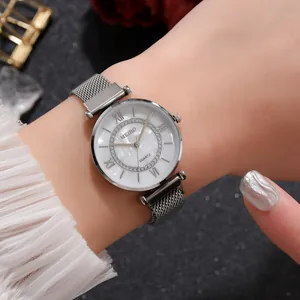 Detail showing women's quartz watch with silver mesh band and sparkling rhinestone dial