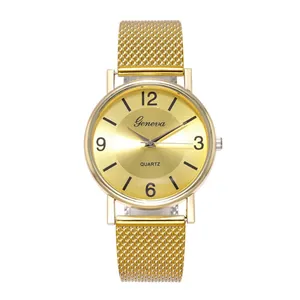 Close-up of golden sunray dial with numeral indices and Milanese mesh steel strap