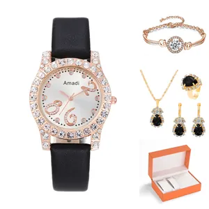 Set orologio e gioielli in oro rosa con pietre nere a goccia in una confezione regalo