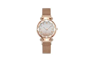 Detail of rose gold mesh strap watch with gradient star dial and diamond cut glass rim