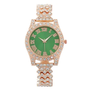 Macro detail of luxury women watch with green dial and rhinestones on rose gold band