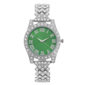 Detailed close-up of emerald green watch dial with Roman numerals and rhinestone strap