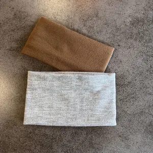 Detail of two-piece wide knitted headbands in brown and light grey cotton blend fabric