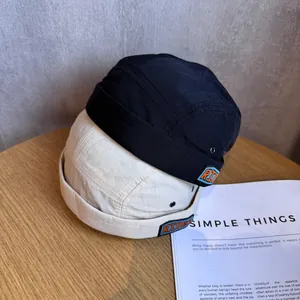 Japanese-style ripstop cotton docker hats in black and beige with Rider embroidery