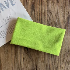 Detail shot of the neon green knitted headband with high elasticity for sports and fitness
