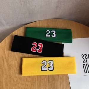 Elastic knitted sports headband set with embroidered number 23 in green, black, and yellow