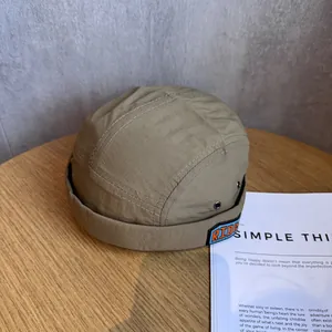 Detail of khaki miki hat with white contrast stitching and RIDE embroidered patch