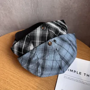 Japanese retro plaid newsboy cap in black and blue patterns on wooden table