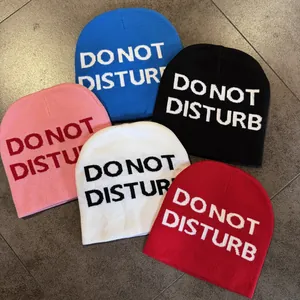 Five assorted knit beanies with Do Not Disturb slogans in blue black pink white and red