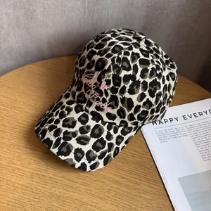 Detail of leopard print baseball cap featuring pink Ciao Bella embroidery on canvas