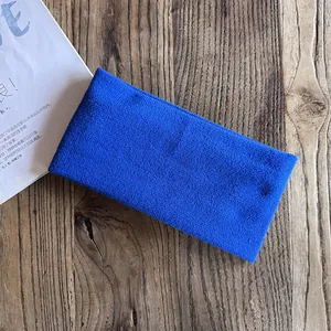 Detail of bright blue ribbed knit headband texture on a rustic wooden background