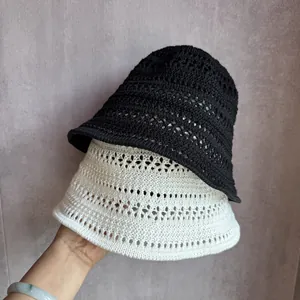 Handwoven hollow-out knit bucket hats in black and cream beige for sun protection