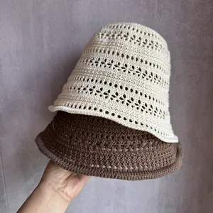 Detailed knit texture of hollow-out breathable straw bucket hats in beige and brown colors