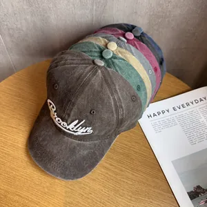 Multiple colors of washed cotton baseball caps with Brooklyn embroidery in a stacked view