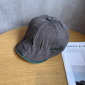 Detail of vintage washed cotton ivy cap with green brim and Natural embroidery