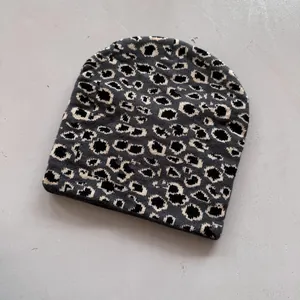 Close-up of the leopard jacquard knit texture on a warm winter beanie hat