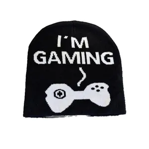 Knitted beanie with 'I'M GAMING' text and gamepad pattern on a clean white background
