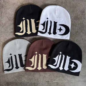 Detailed close-up of knitted beanie texture featuring gothic letter and moon pattern
