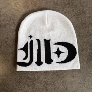 Close-up of gothic jacquard pattern and star-moon symbols on white knitted beanie