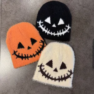 Knit Halloween beanies with ghost faces in orange, black, and white faux mink fur