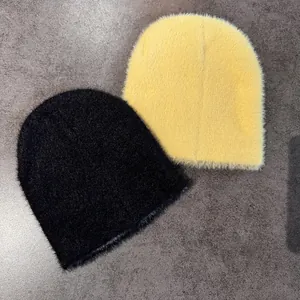 Fuzzy knitted beanies in black and yellow colors featuring a plush faux mink texture