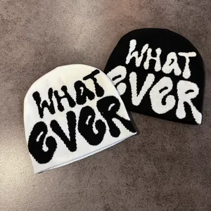 Detailed knit texture of black and white beanies with WHATEVER graffiti pattern