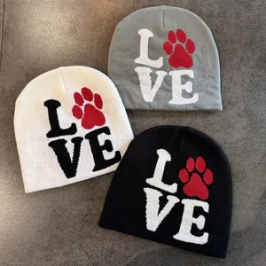Winter knit beanies in white, grey, and black featuring LOVE lettering with red paw print