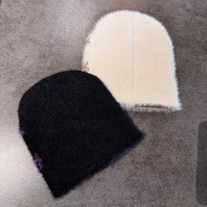 Close-up of fuzzy knit beanies showing the soft faux fur texture and jacquard knit detail