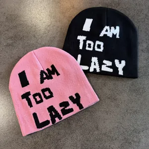 Knitted beanies in pink and black featuring I AM TOO LAZY pixel font text design
