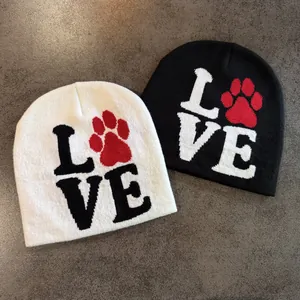 Knitted beanie set in black and white featuring LOVE lettering and red paw print design