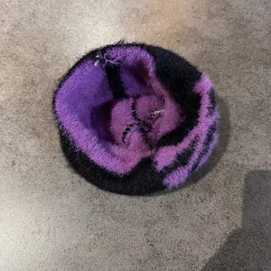 Detailed view of fluffy purple and black knit fabric texture on the Halloween beanie