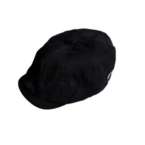 Classic black cotton newsboy cap with white side embroidery in a minimalist style