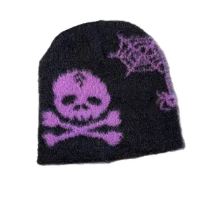 Knitted beanie with purple skull and spider web pattern in fluffy faux mink fur